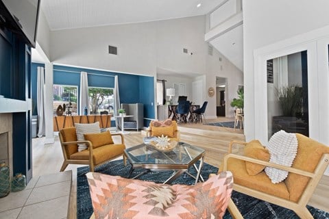 a living room with couches and chairs and a fireplace